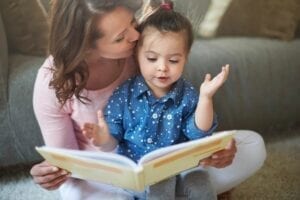 Mother reading book to young child