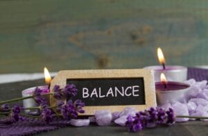 Balance sign and lit candles